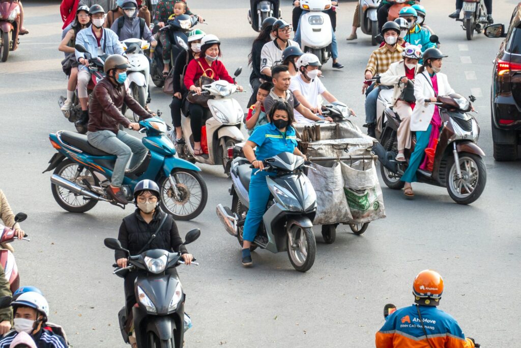 A group of people riding motorcycles down a street